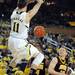 Michigan freshman Nik Stauskas hangs from the rim after dunking the ball in the second half against Iowa at Crisler Center on Sunday, Jan. 6. Michigan beat Iowa 95-67 in the Big Ten home opener. Melanie Maxwell I AnnArbor.com